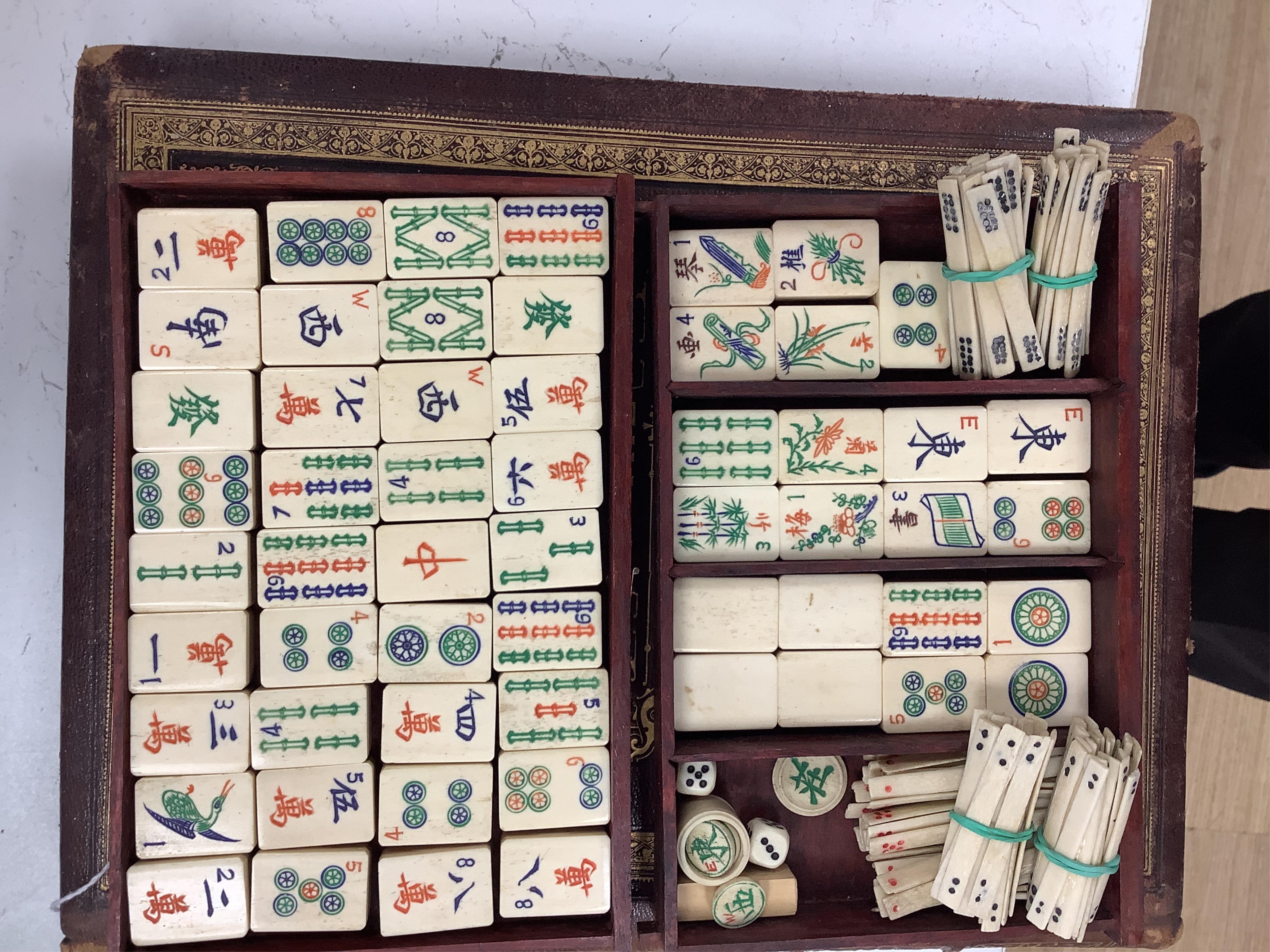 A cased Chinese mahjong set, bone pieces
